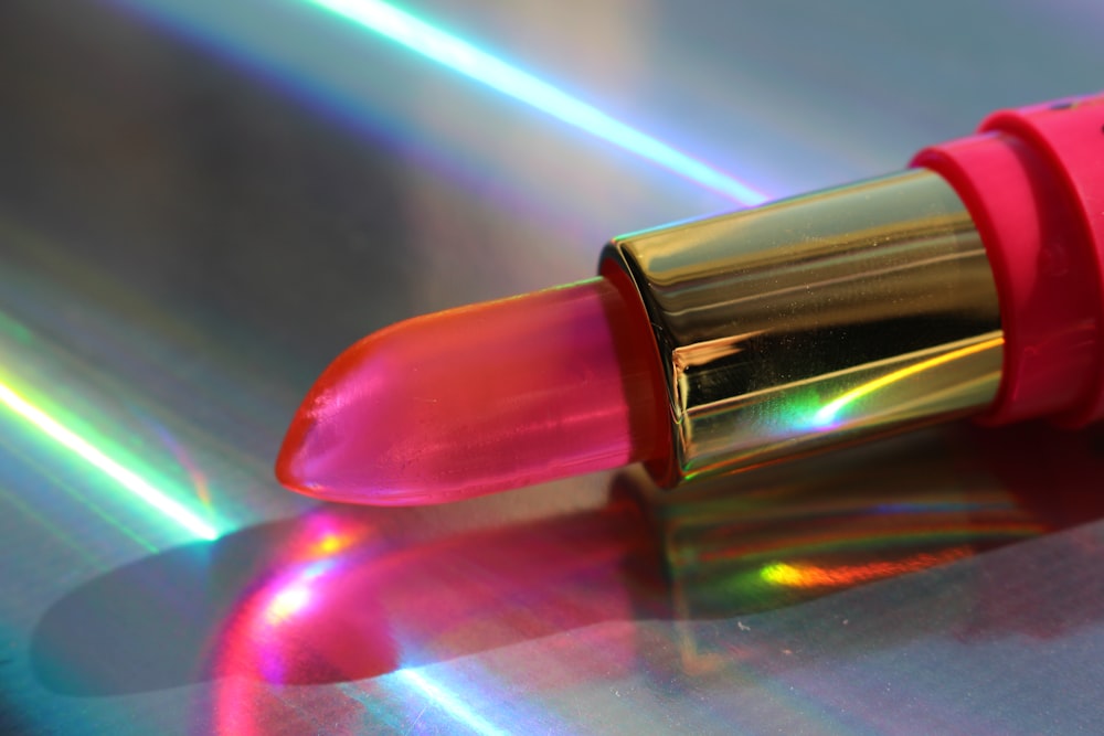 a close up of a lipstick on a shiny surface
