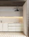 A sleek, modern modular kitchen with warm wooden cabinets and smart appliances glowing softly.