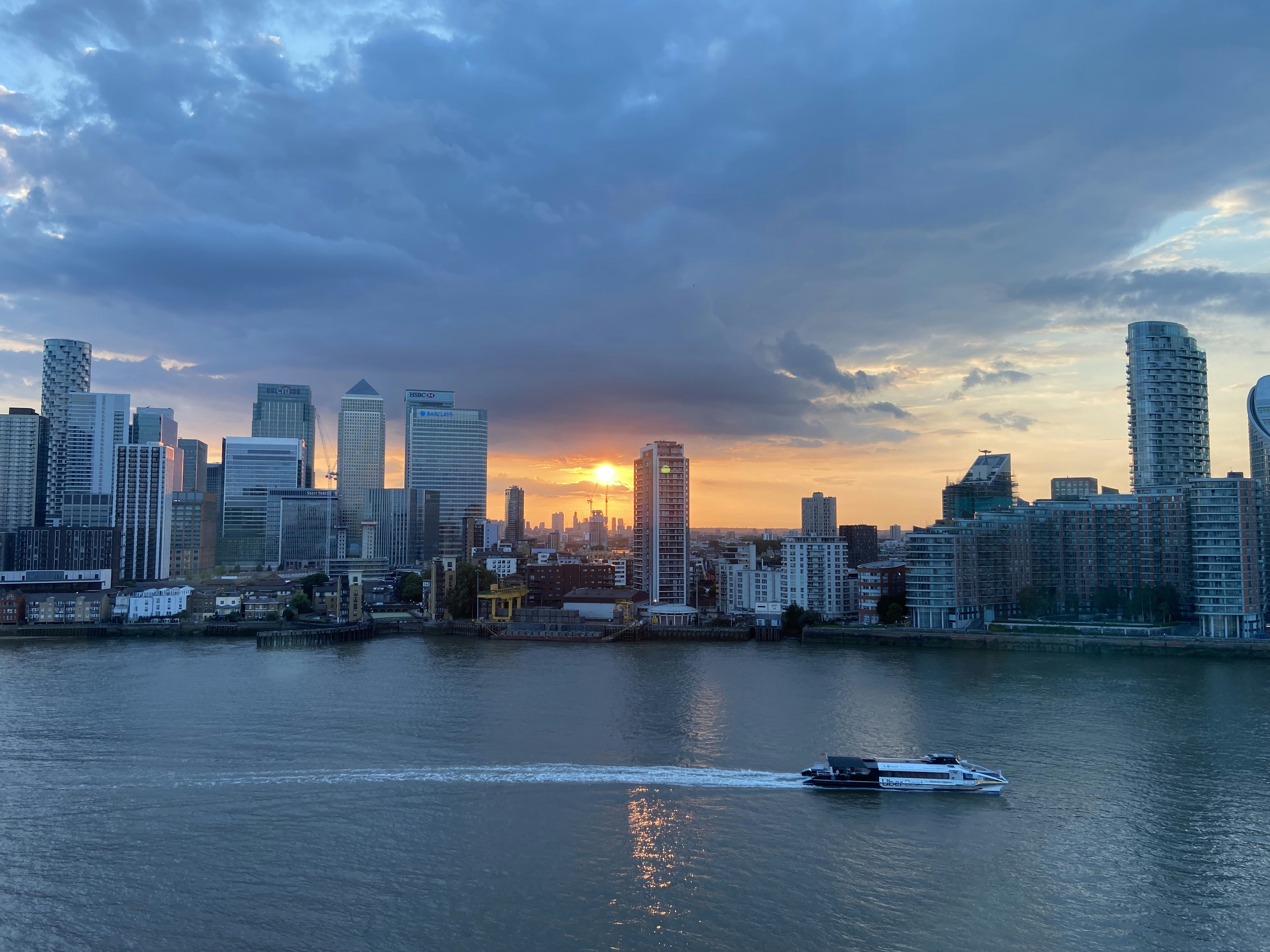 a boat in the water with a city in the background