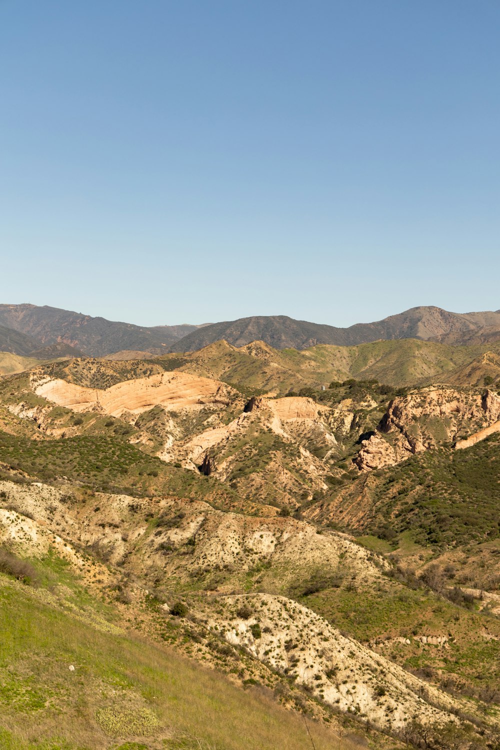 a view of a mountain range with hills in the background