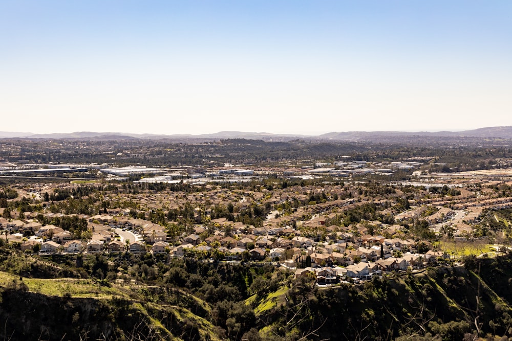 a scenic view of a city surrounded by mountains