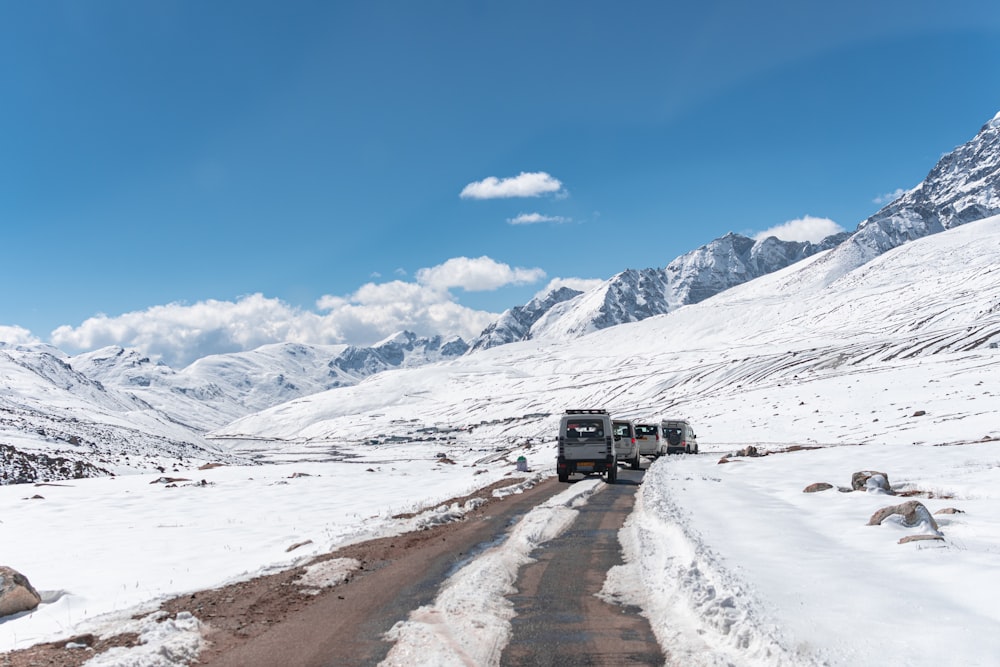 a truck driving down a snow covered road