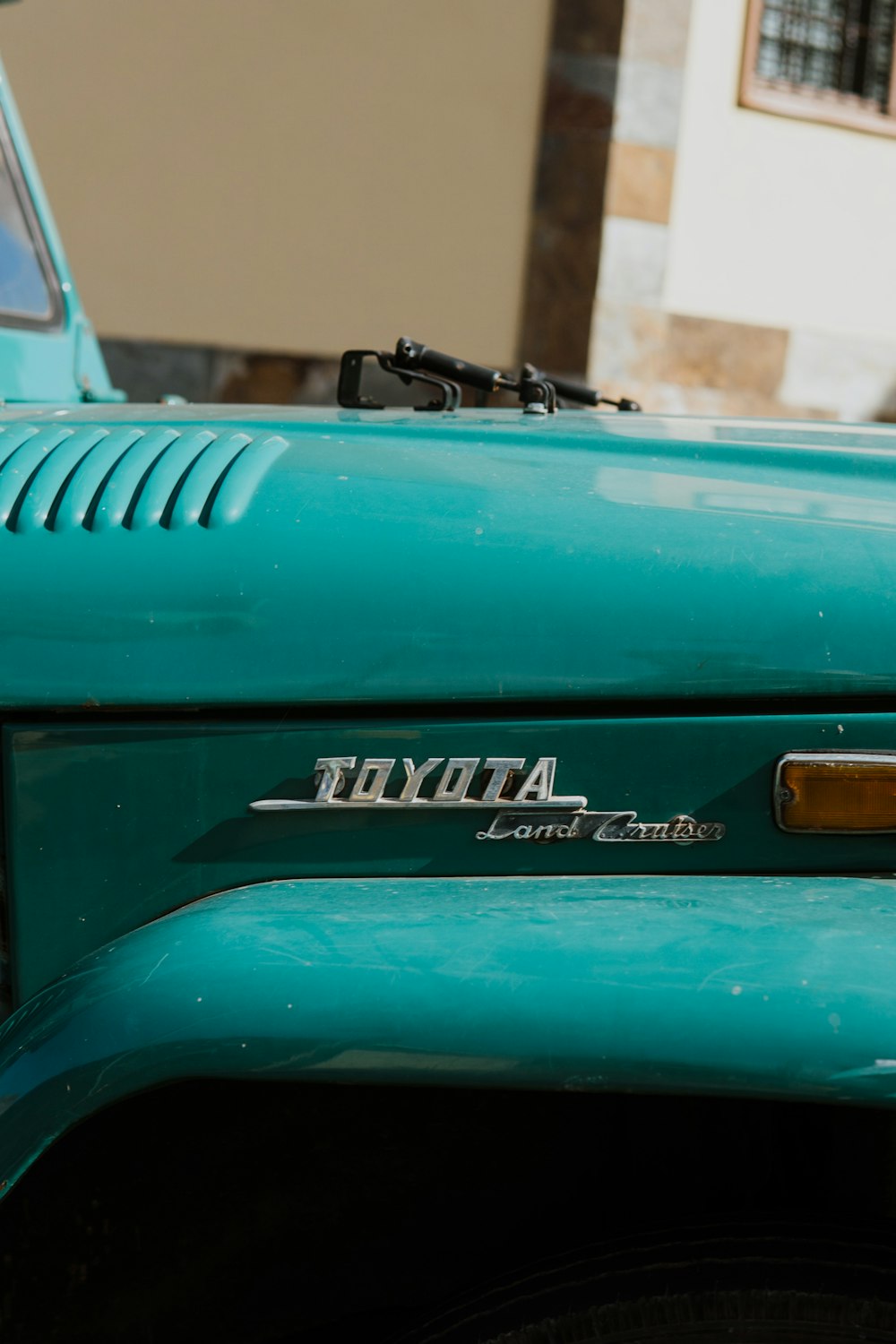 a close up of the front end of a green truck