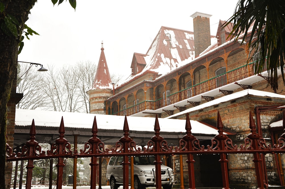 a white van parked in front of a building covered in snow