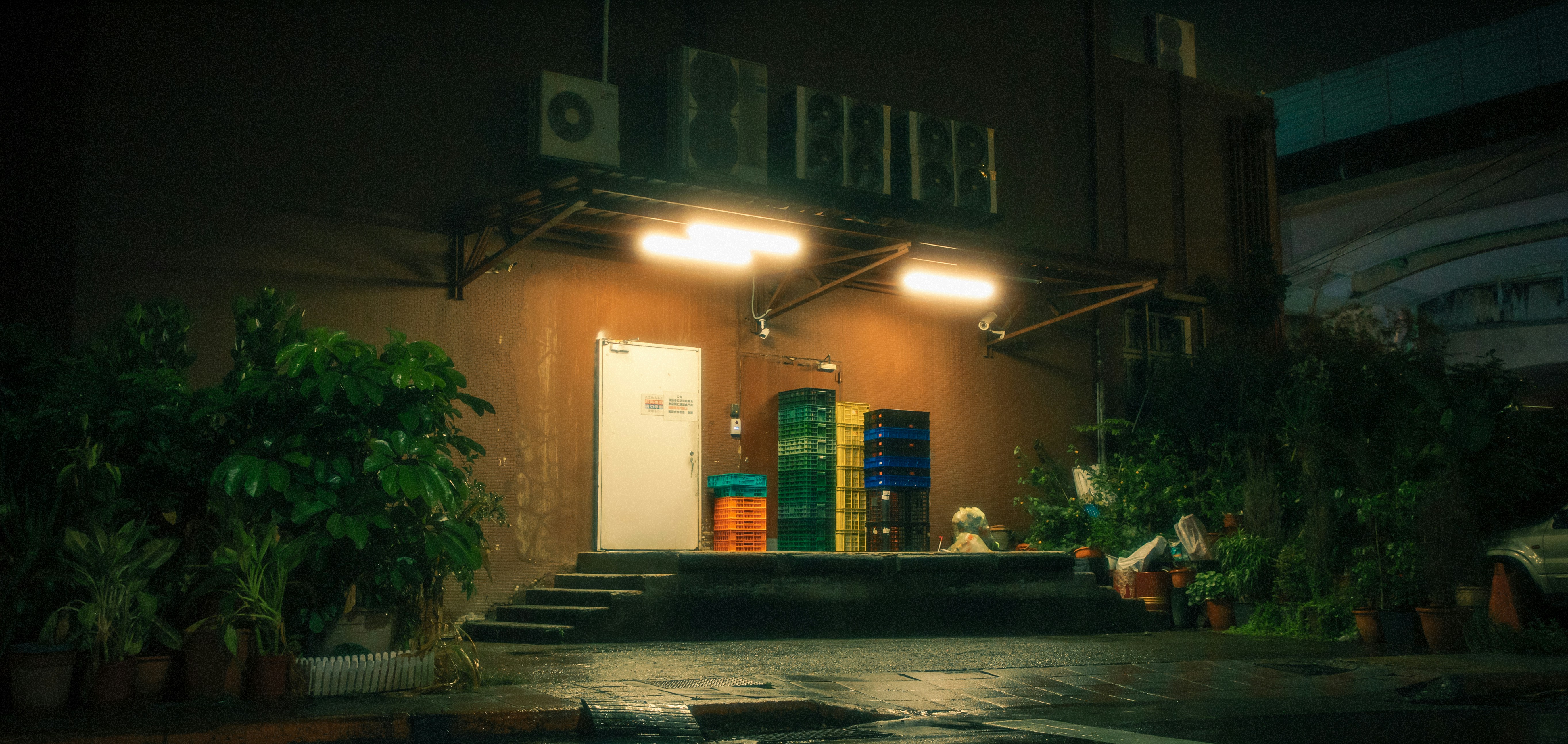 a building that has a bunch of plants in front of it