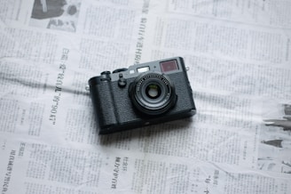 a camera sitting on top of a newspaper