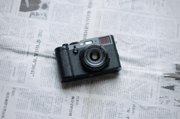a camera sitting on top of a newspaper