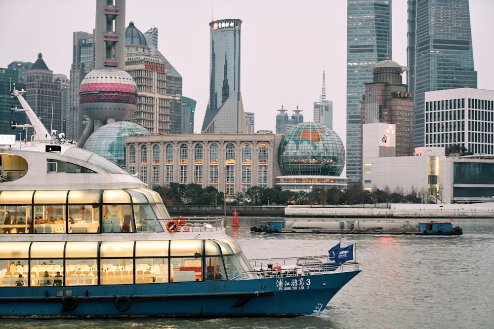 a boat is in the water in front of a city