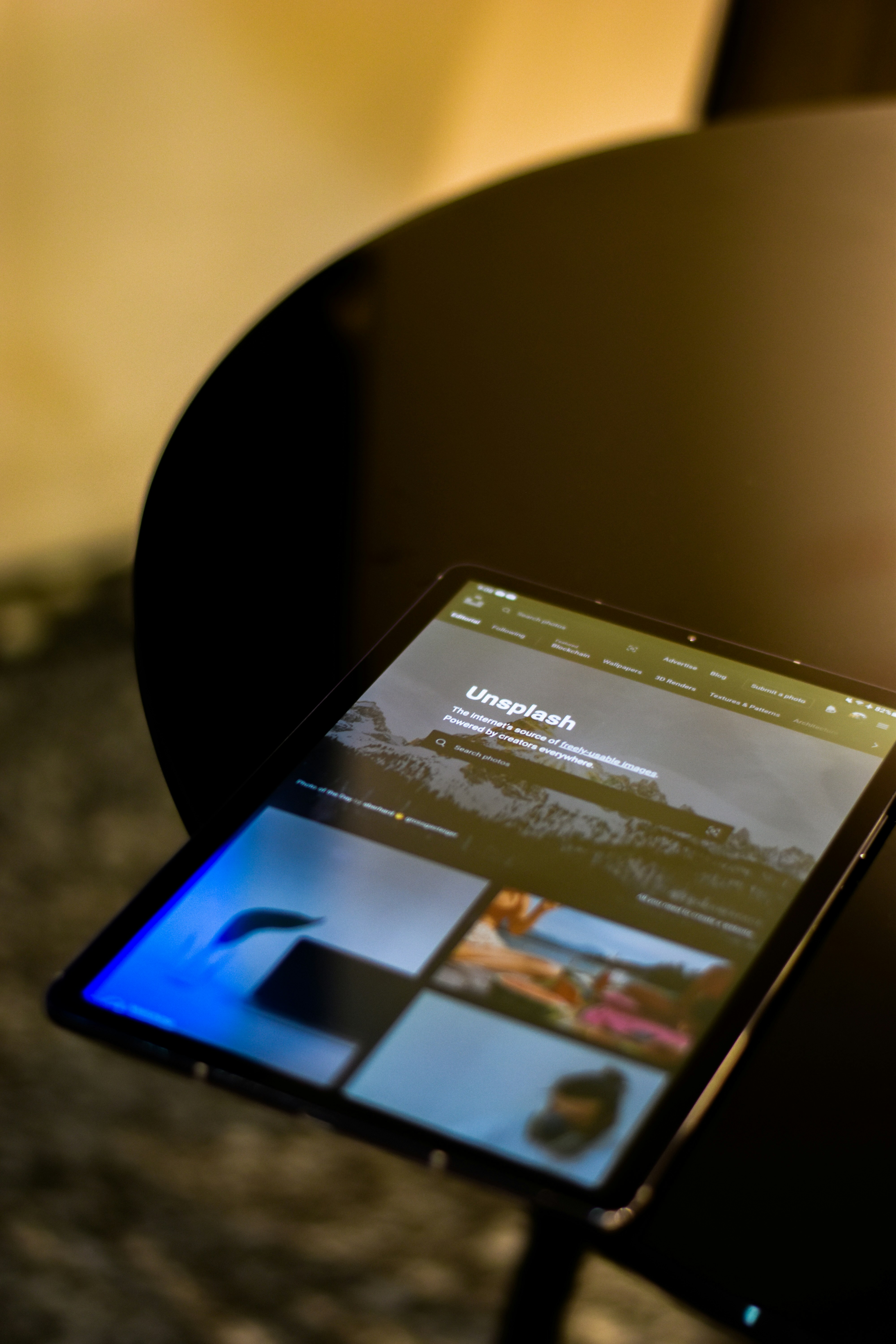a tablet sitting on top of a black table