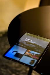 a tablet sitting on top of a black table