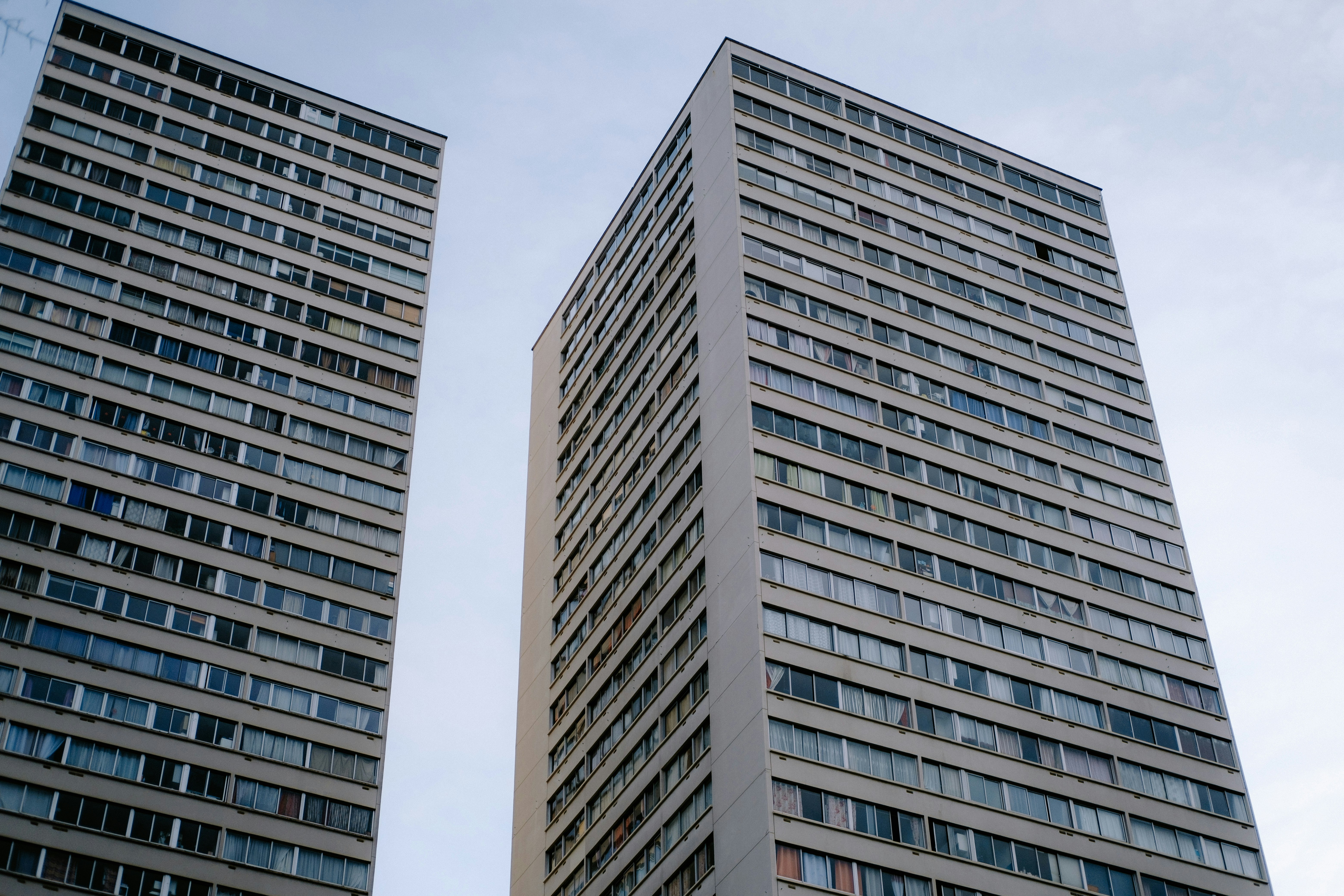 a couple of tall buildings sitting next to each other