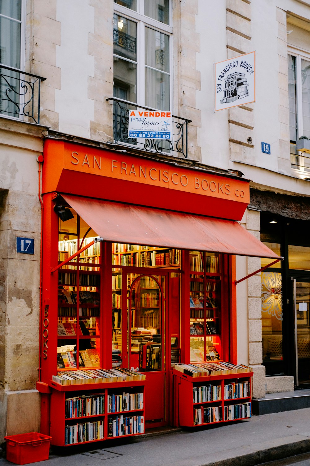 a red book store with a red awning
