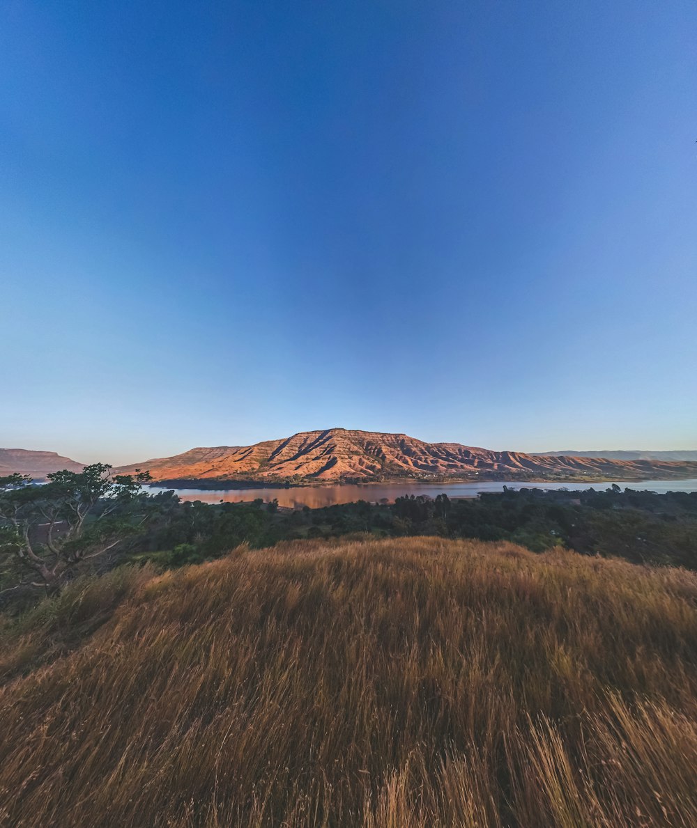 a view of a mountain with a lake in the distance