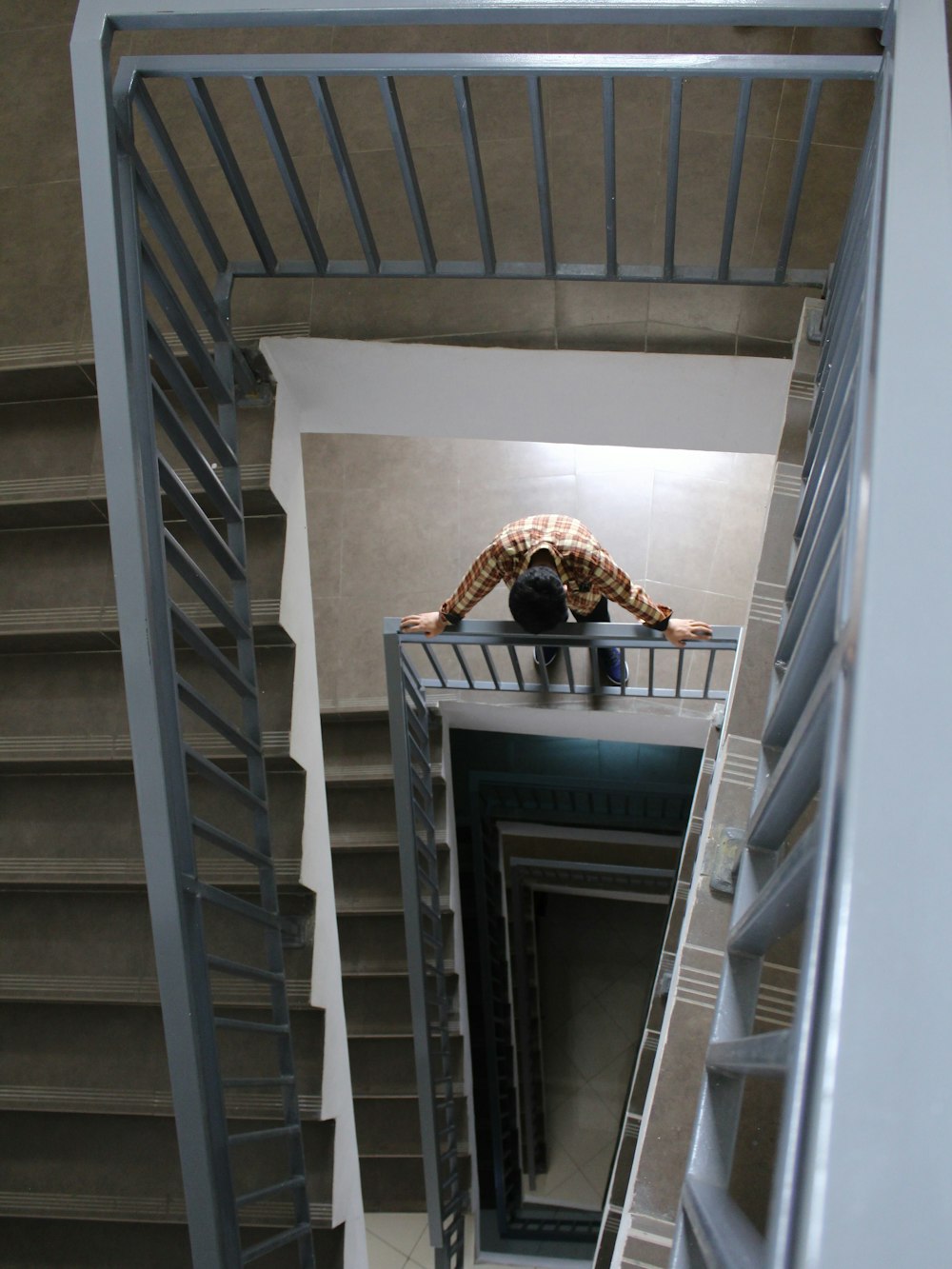 a person standing on top of a metal staircase