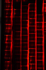 A dynamic visualization of data streams flowing into a structured warehouse, highlighted by red grid accents.