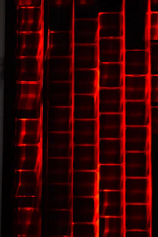 A dynamic visualization of data streams flowing into a structured warehouse, highlighted by red grid accents.