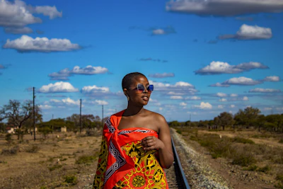 A woman in a printed wrap by the railway near Siteki — Eswatini