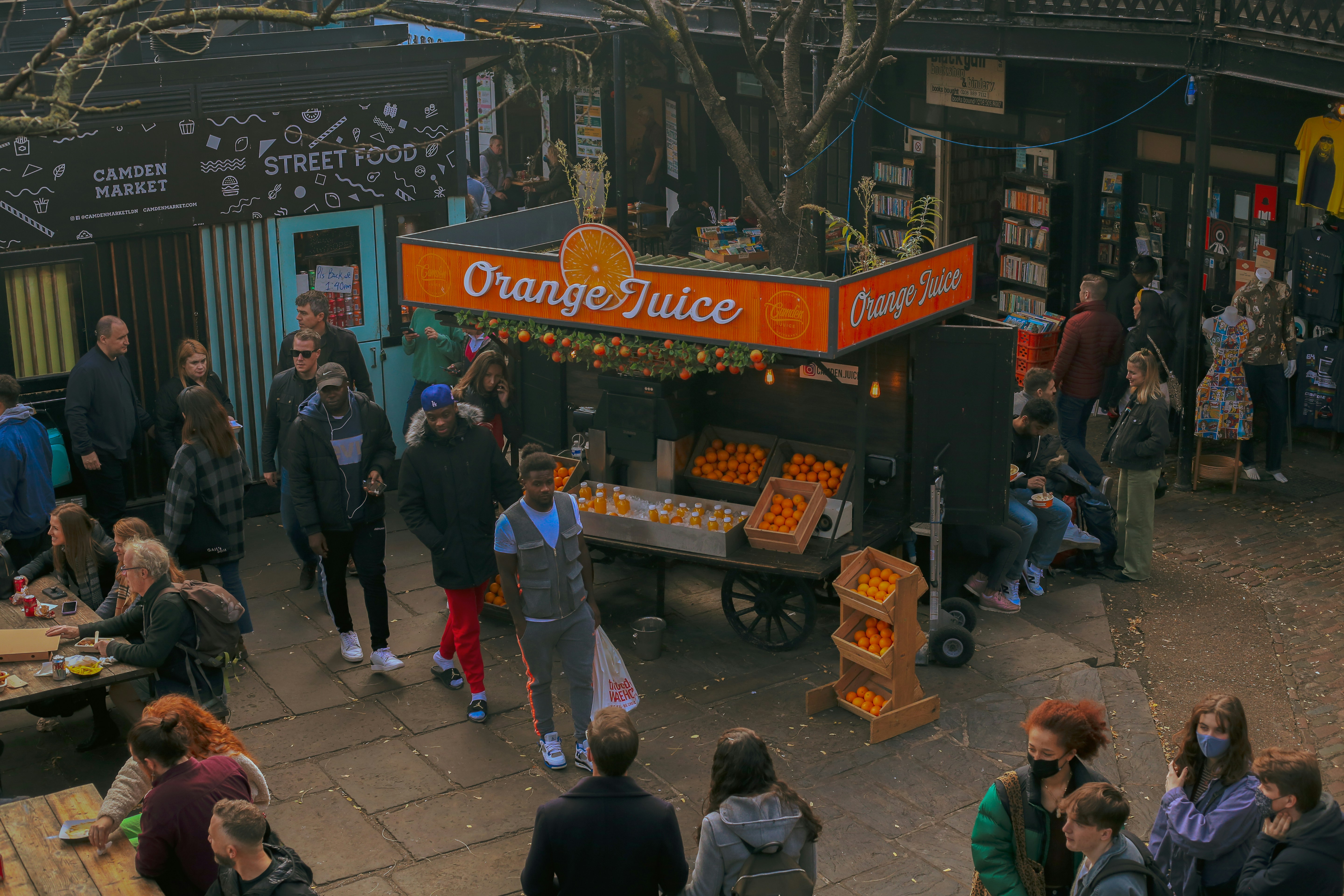 a group of people standing around a food stand