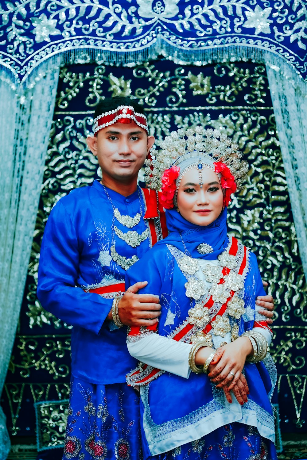 a man and a woman dressed in traditional indian garb