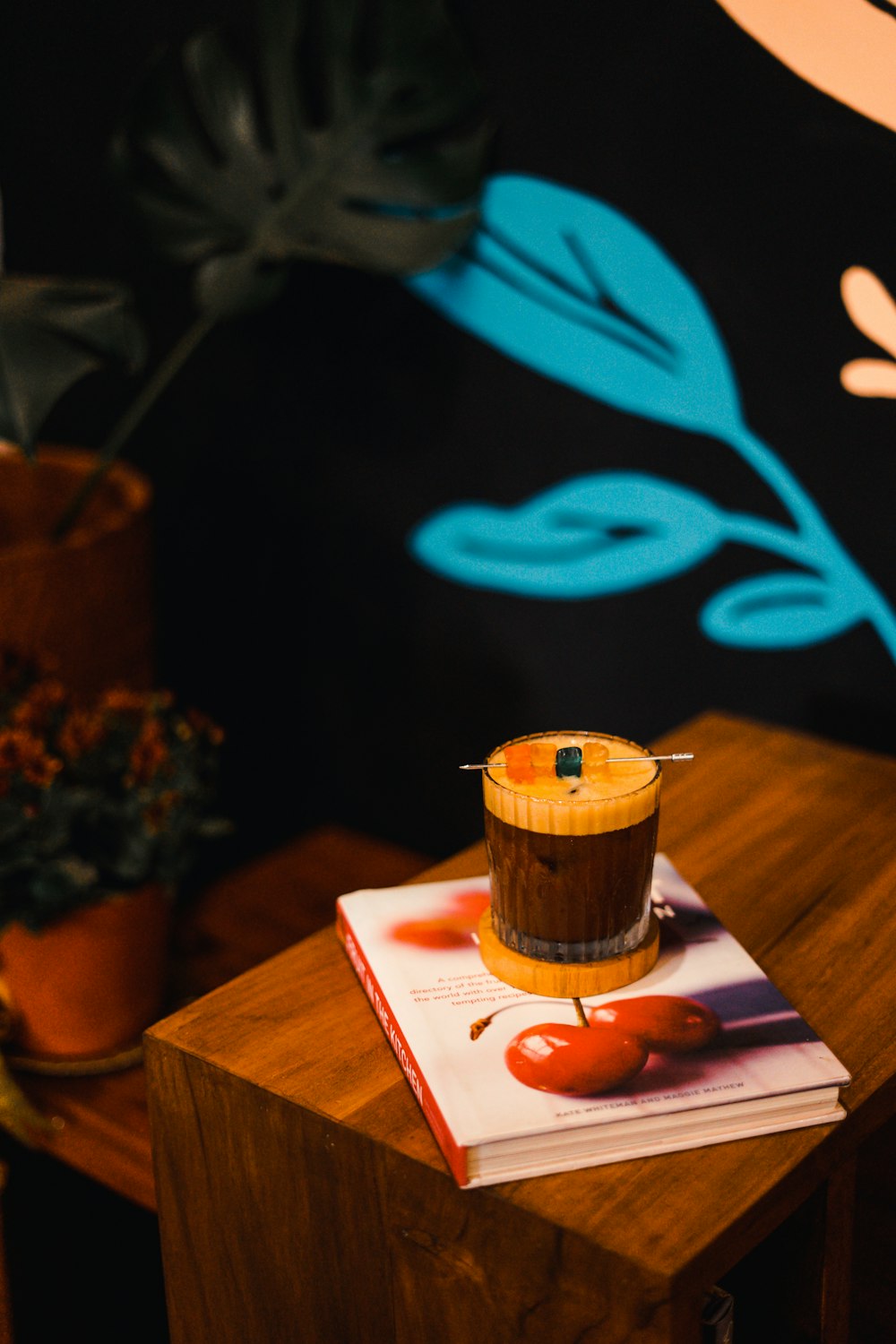 a cupcake sitting on top of a book on a table