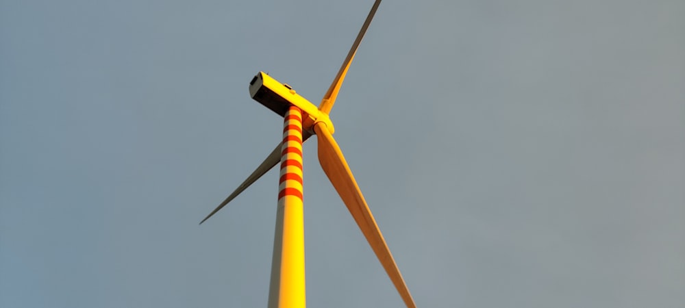 a close up of a wind turbine against a blue sky