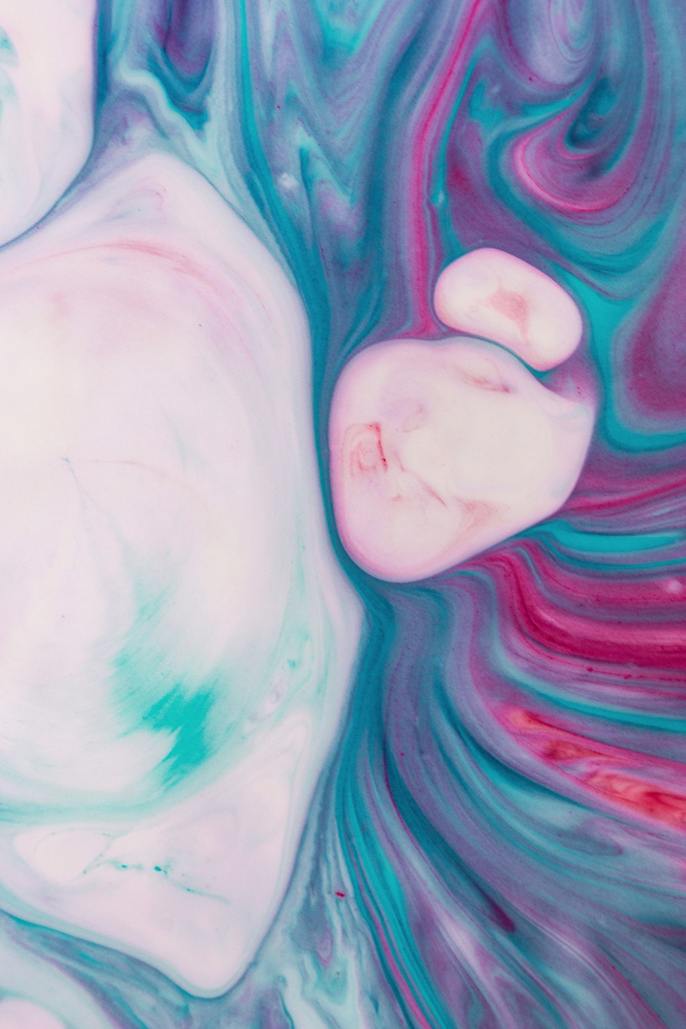 a close up of a pink and blue swirl