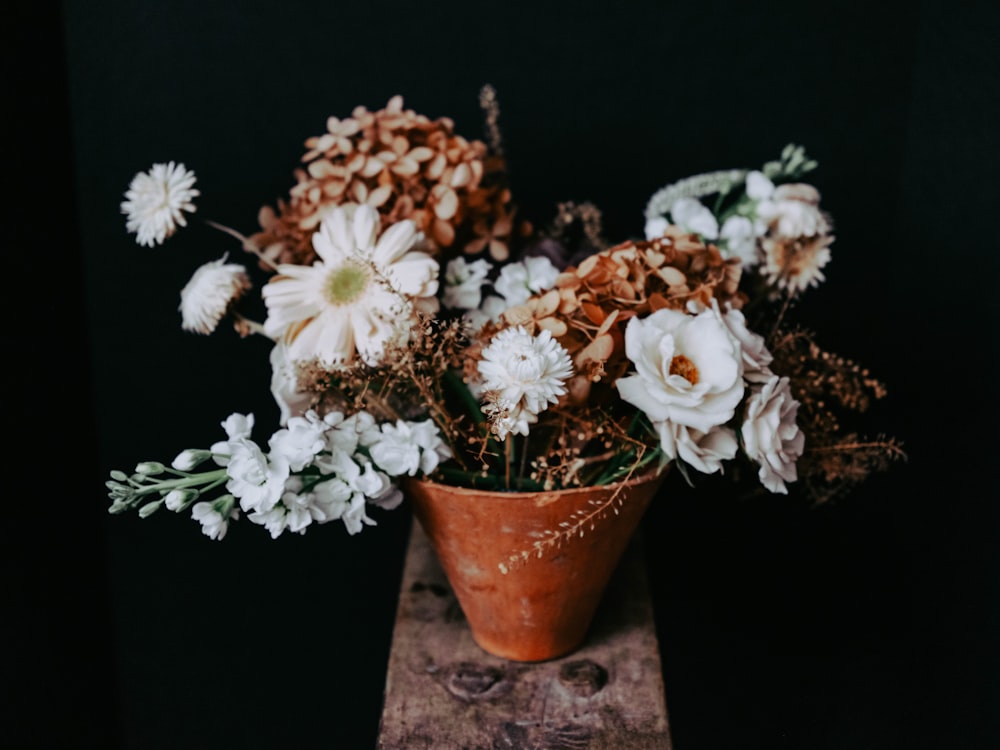 a vase filled with lots of white flowers