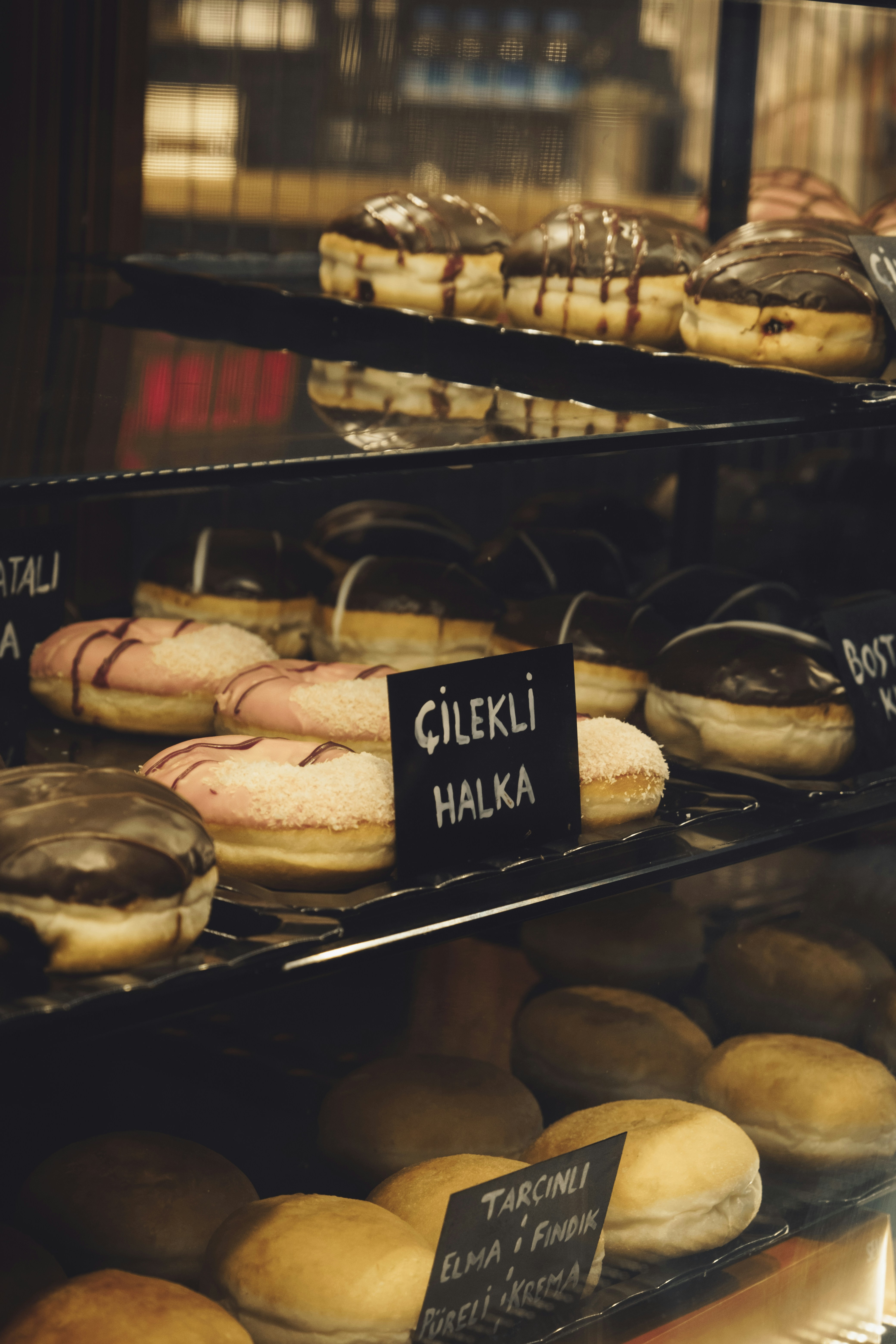 a display case filled with lots of different types of donuts