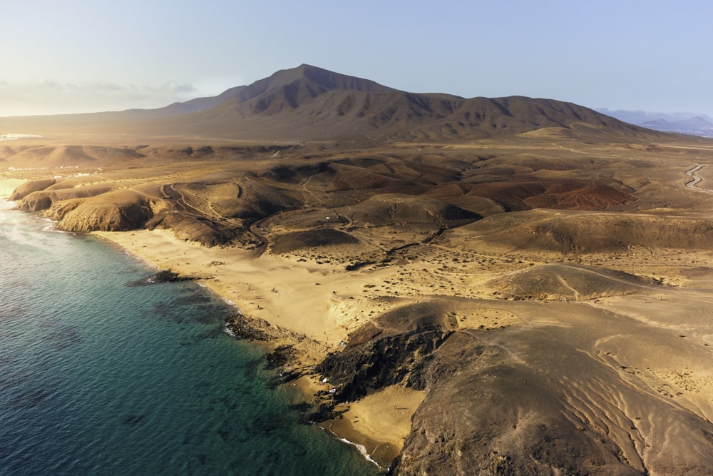 an aerial view of a beach and mountains