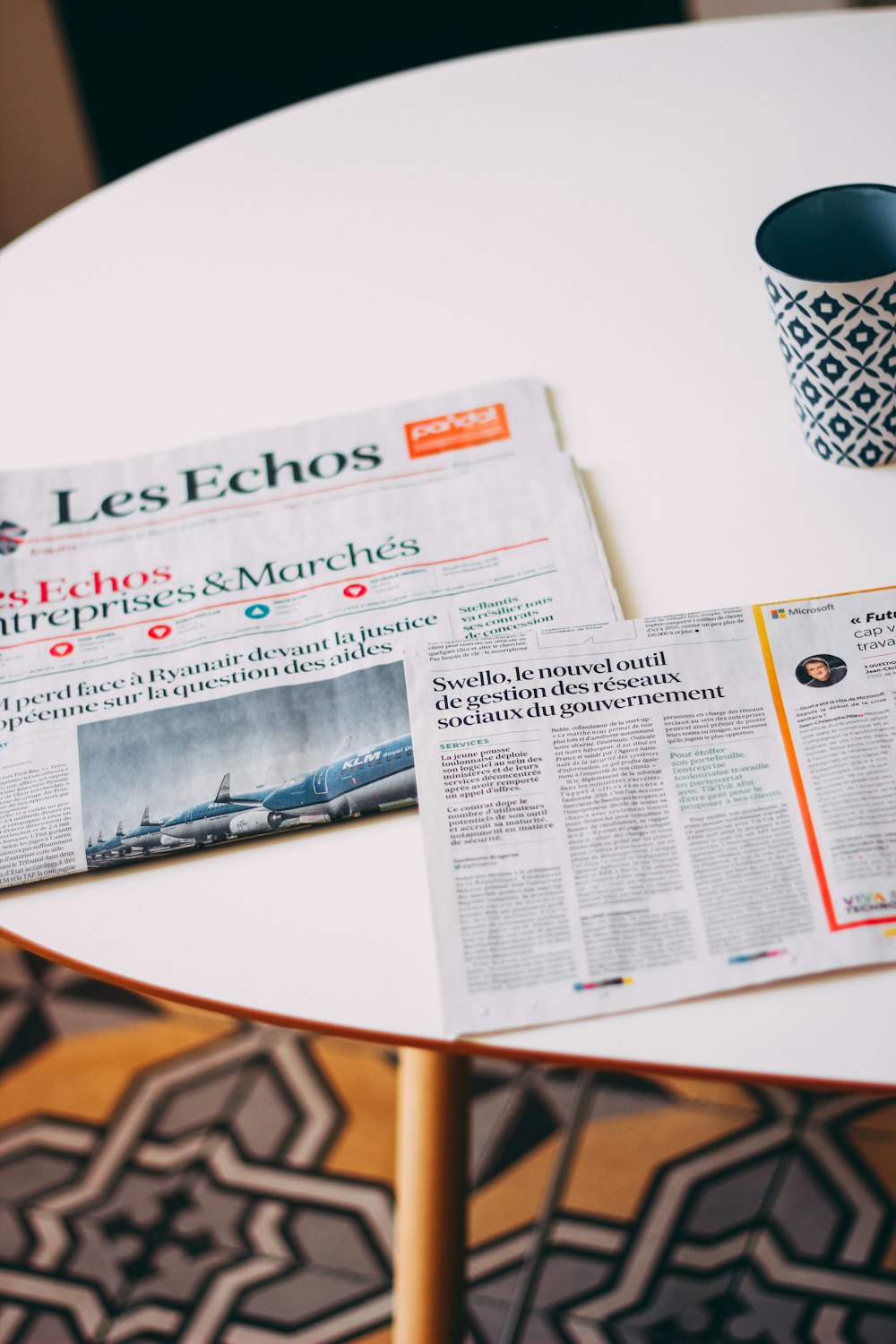 a newspaper sitting on top of a white table