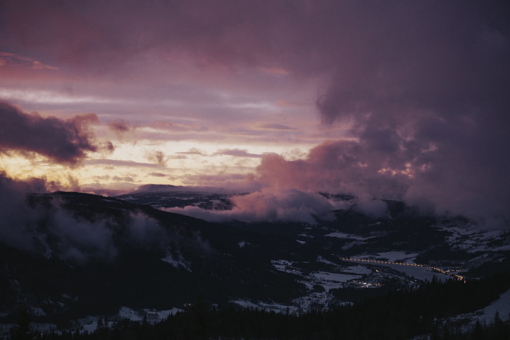 a view of a mountain range with clouds in the sky