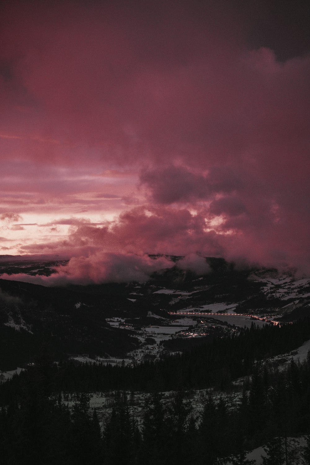 a view of a mountain covered in snow and clouds