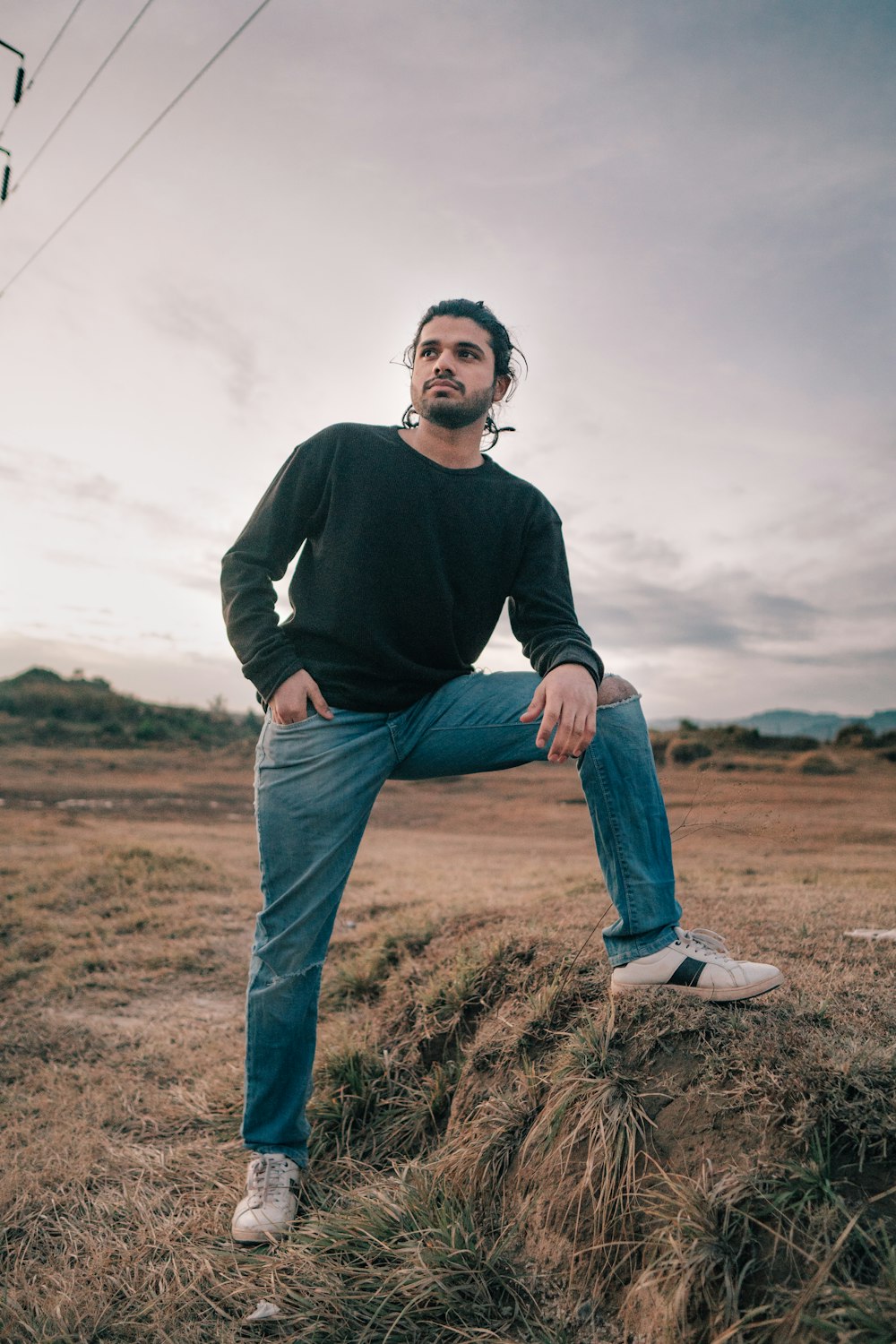 a man standing on top of a dry grass field