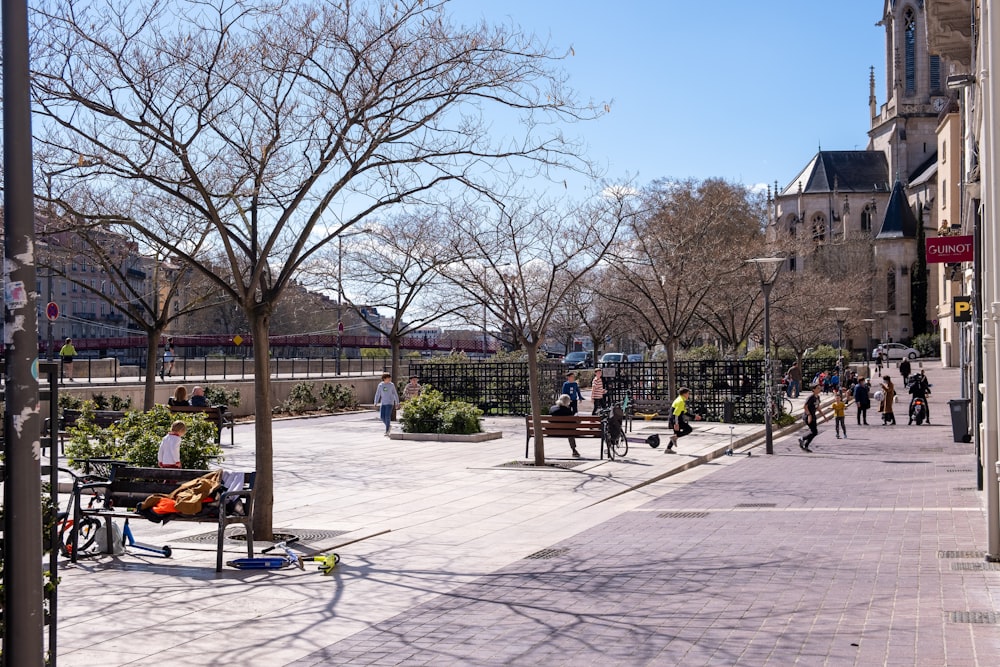 a group of people sitting on a bench in a park