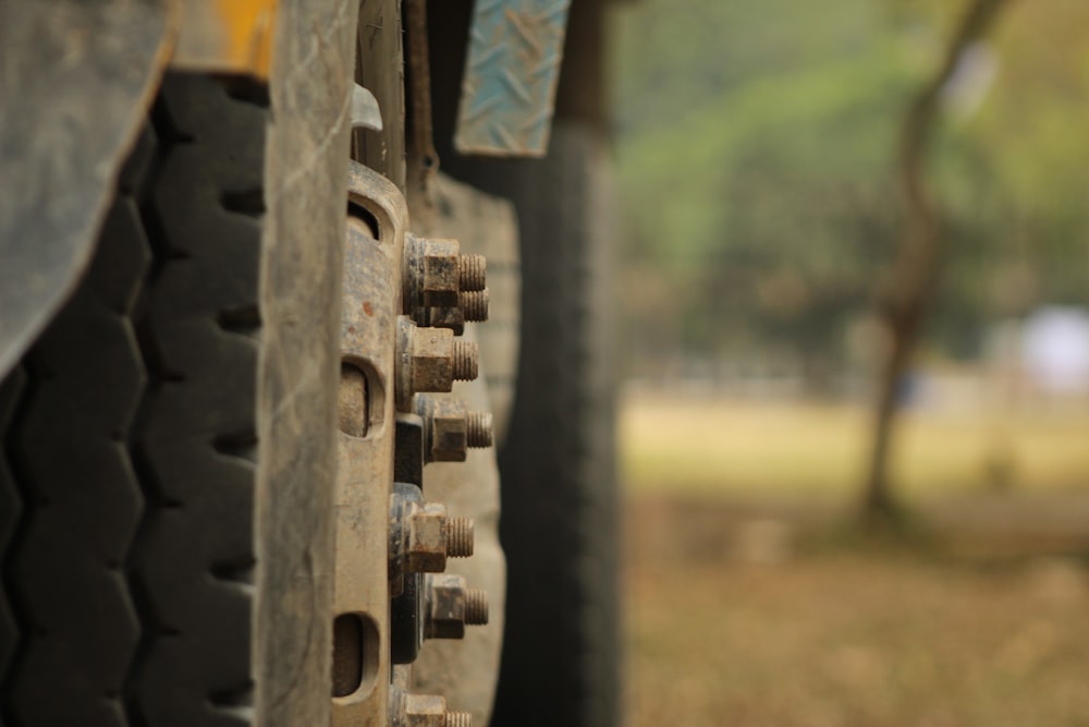 a close up of a truck tire with a tree in the background