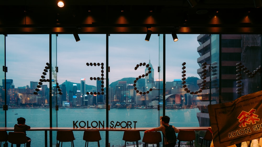 a person sitting at a table in front of a window