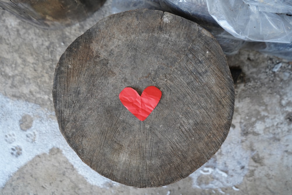 a piece of wood with a red heart on it