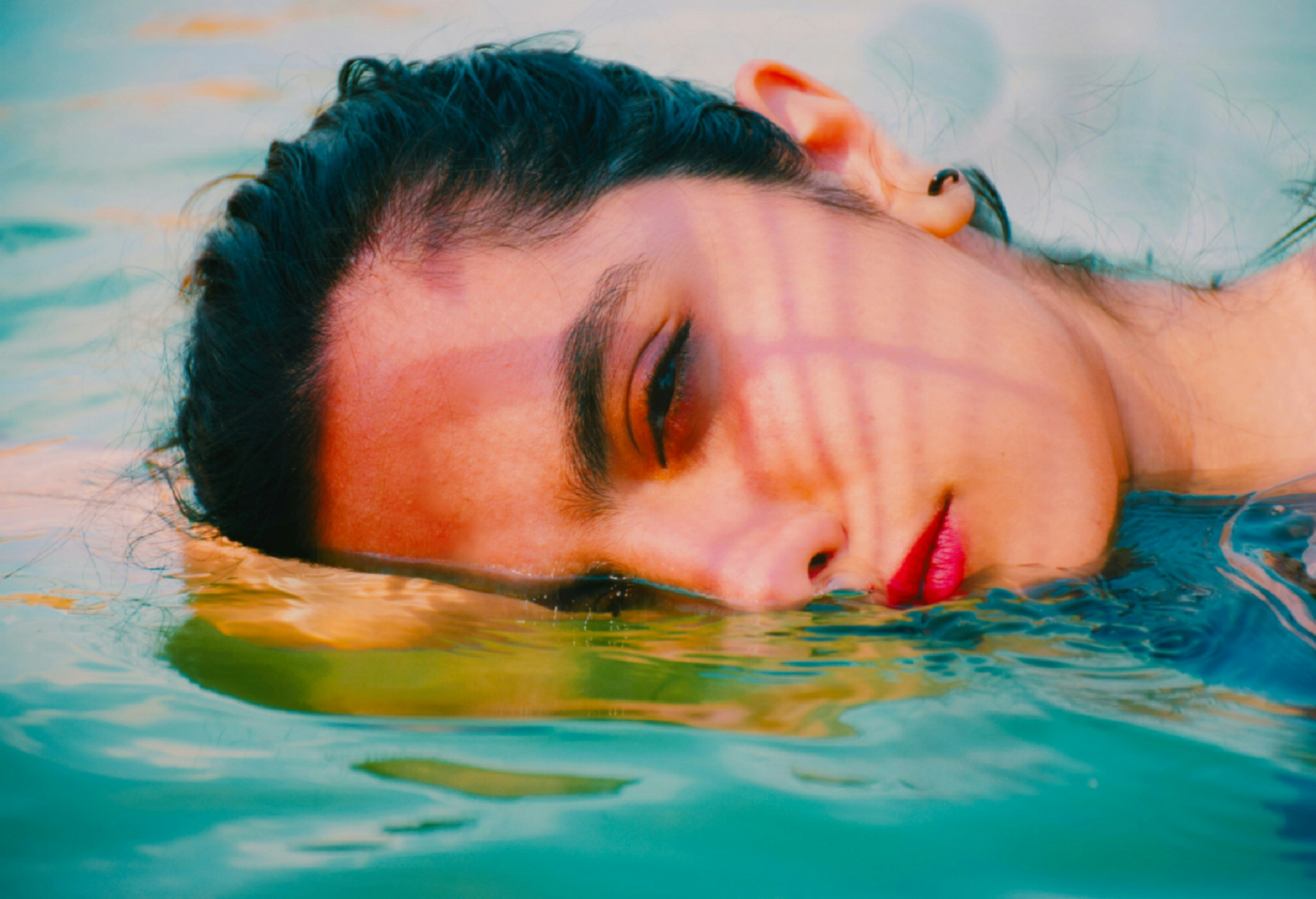 a man swimming in a pool of water