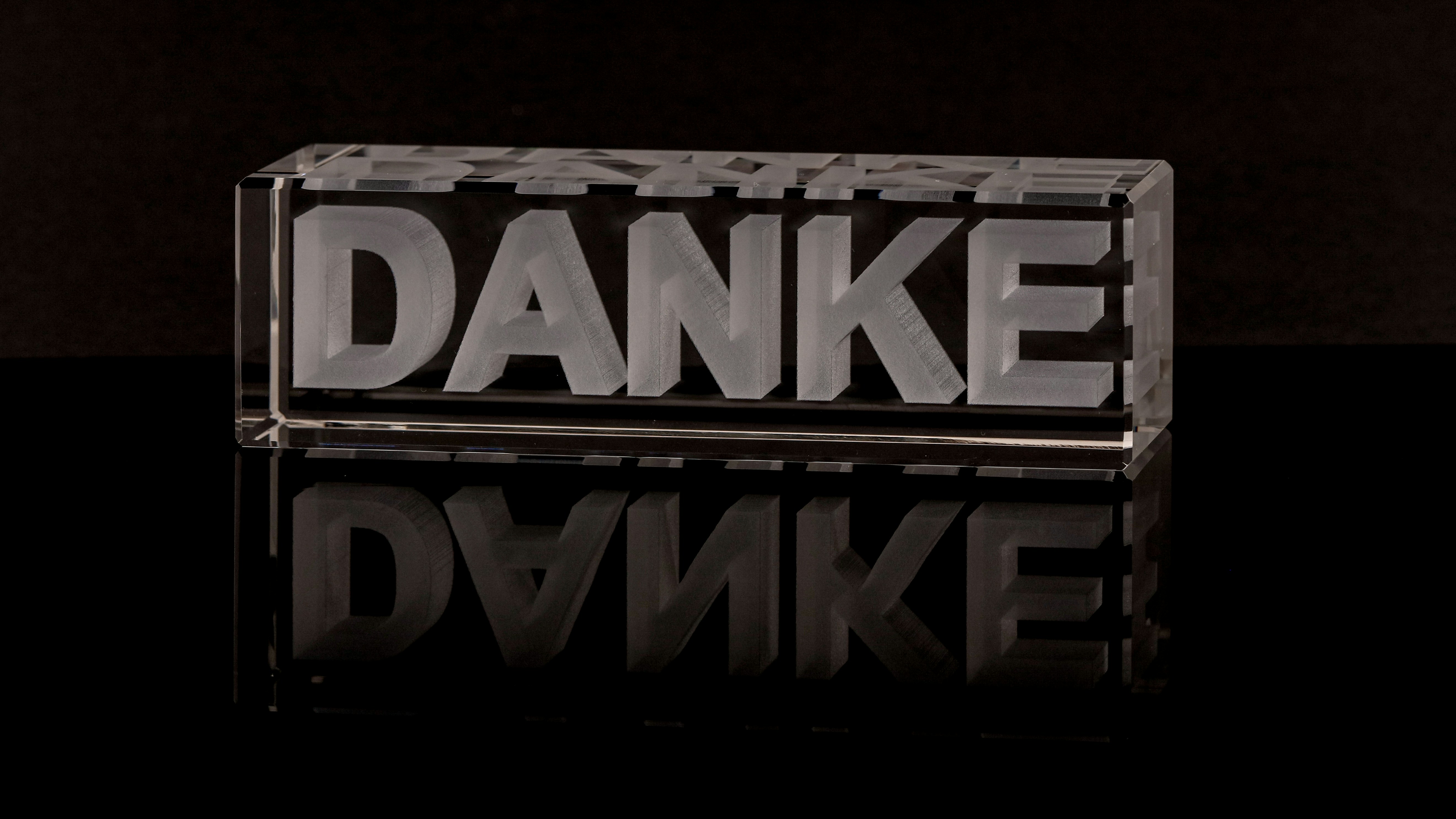 a glass block with the word danke on it