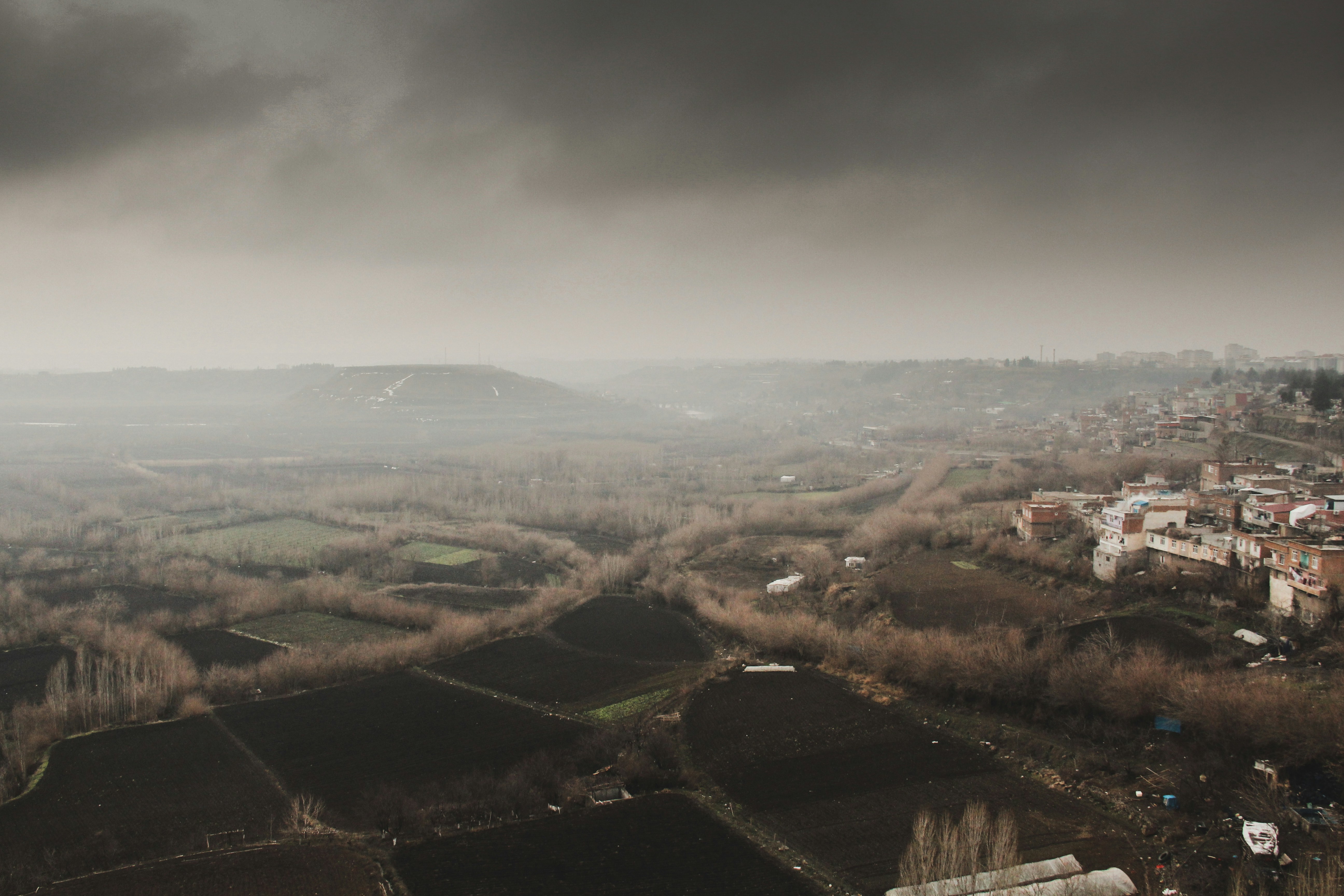 an aerial view of a city with a dark sky