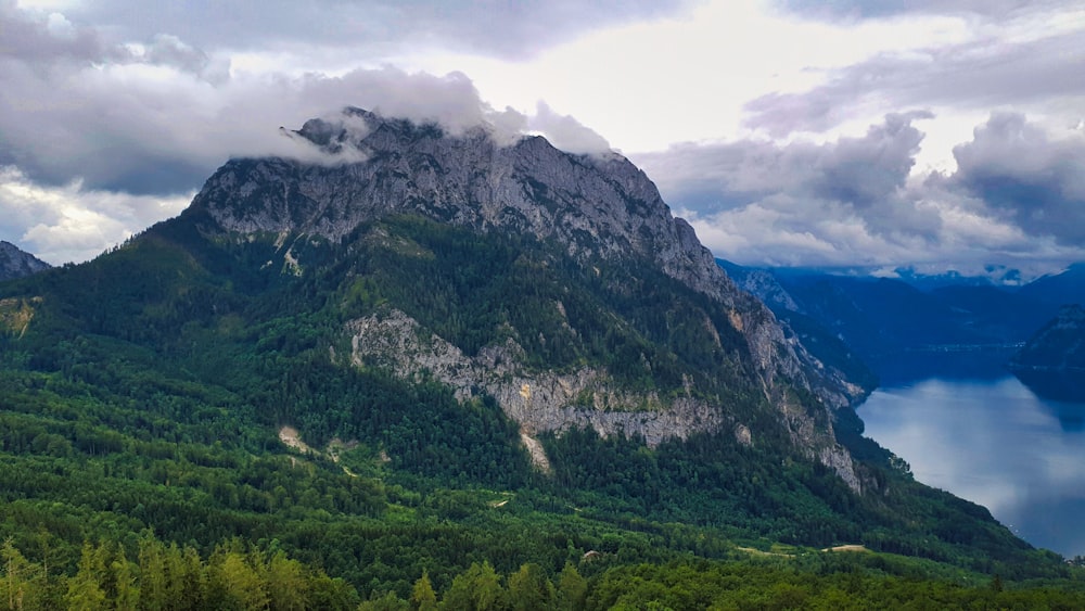 a large mountain with a lake below it