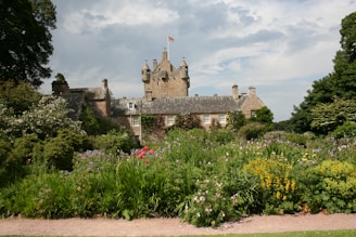 a large building surrounded by lots of trees and flowers