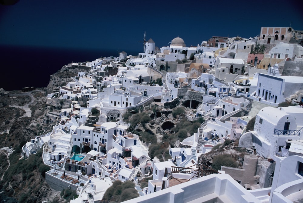 an aerial view of a white village on a cliff