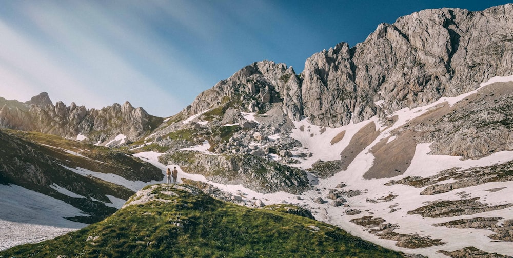 a man standing on top of a snow covered mountain