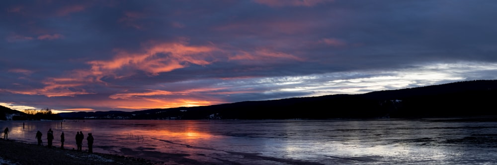 the sun is setting over a body of water