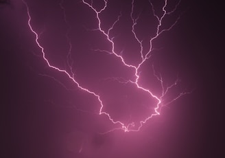 Close-up of a glowing crimson lightning bolt striking an anvil, symbolizing powerful email campaigns.