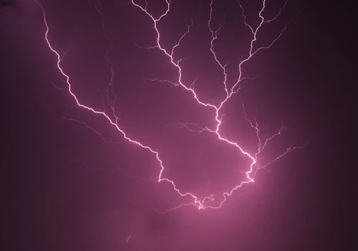 A dramatic black-and-white still from a recent audiovisual campaign featuring dynamic lightning effects.