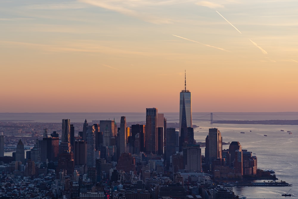 a view of a city at sunset from the top of a hill