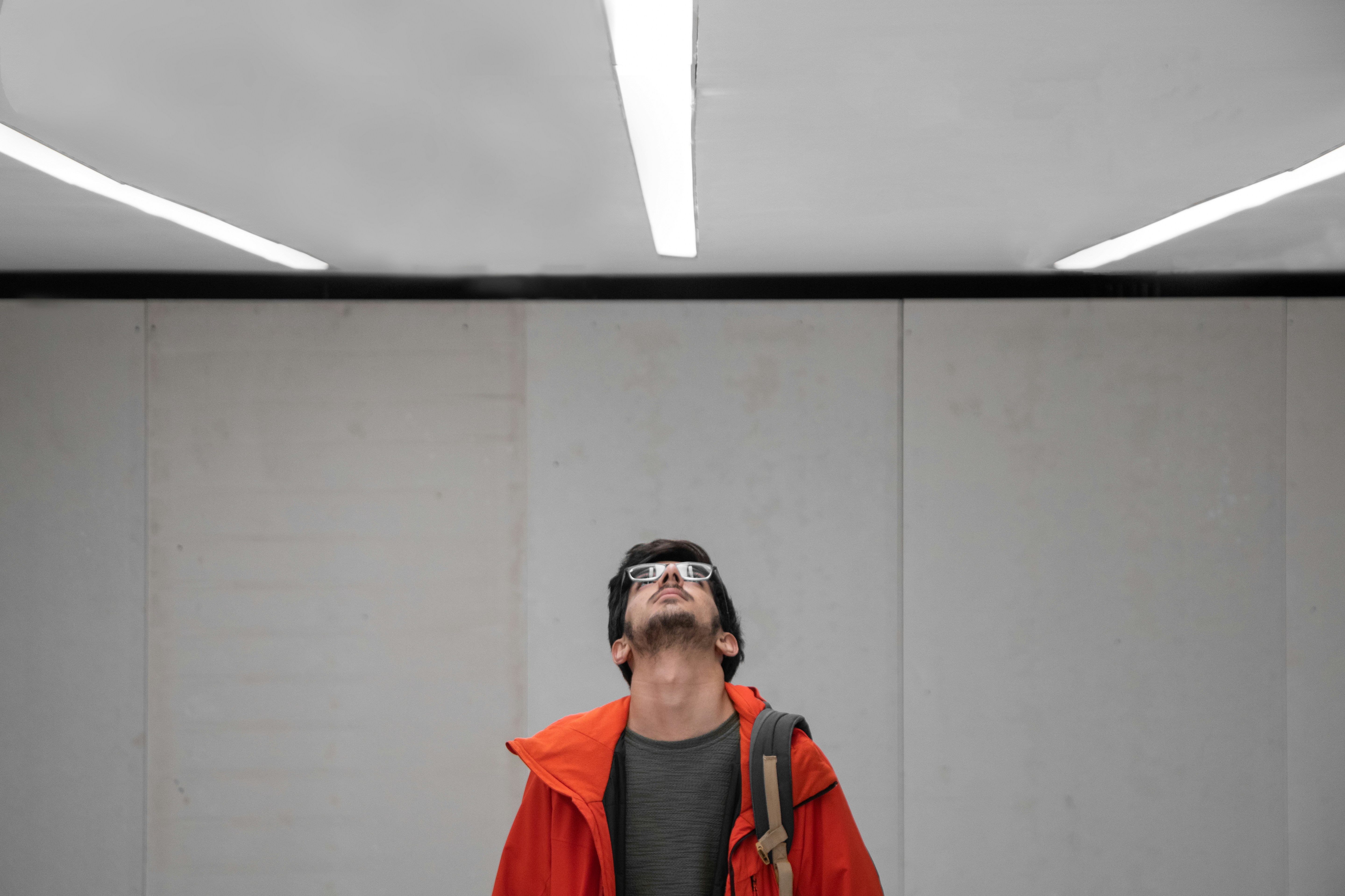 a man with a backpack and goggles standing in a room