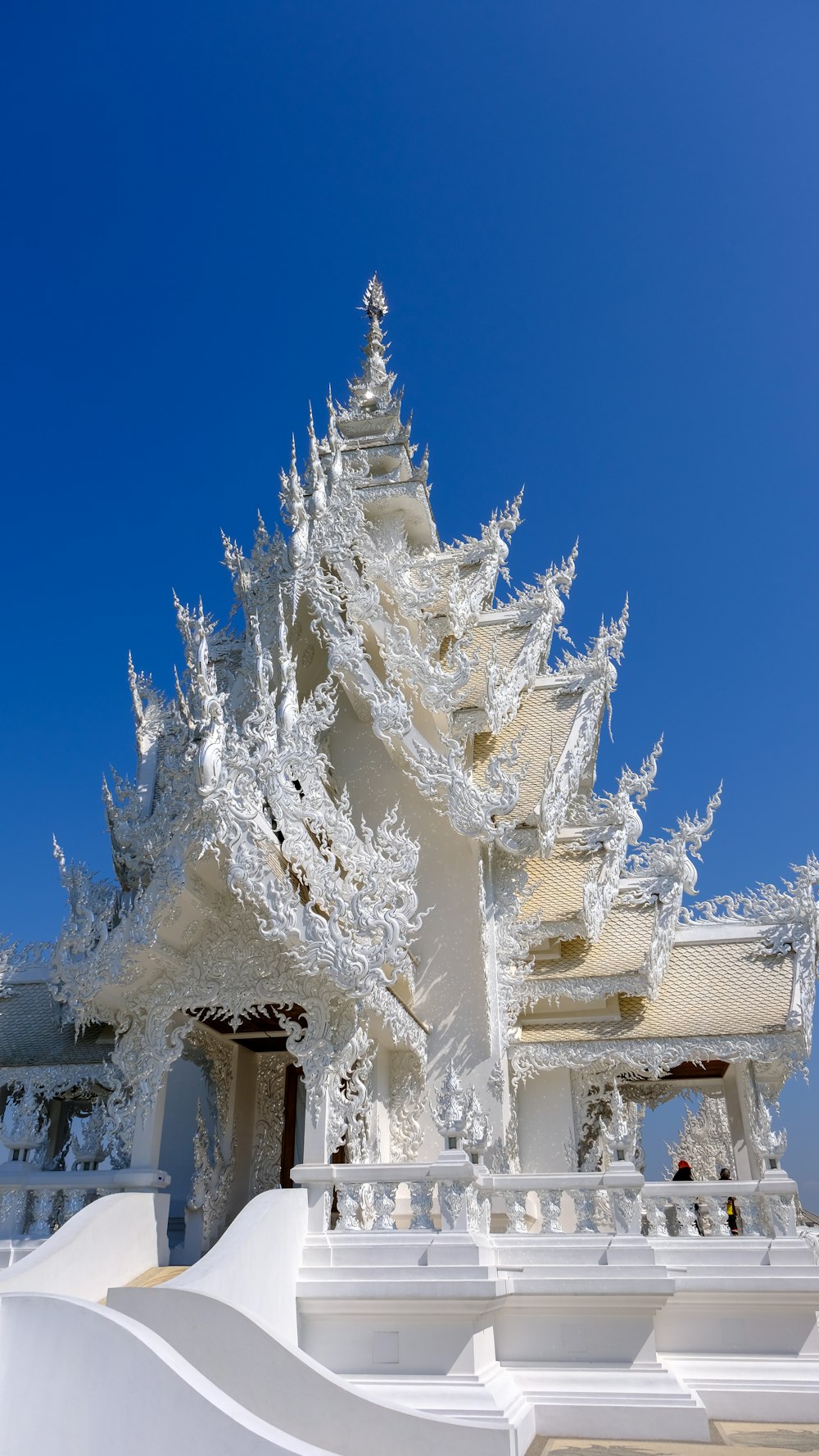 a white building with a blue sky in the background